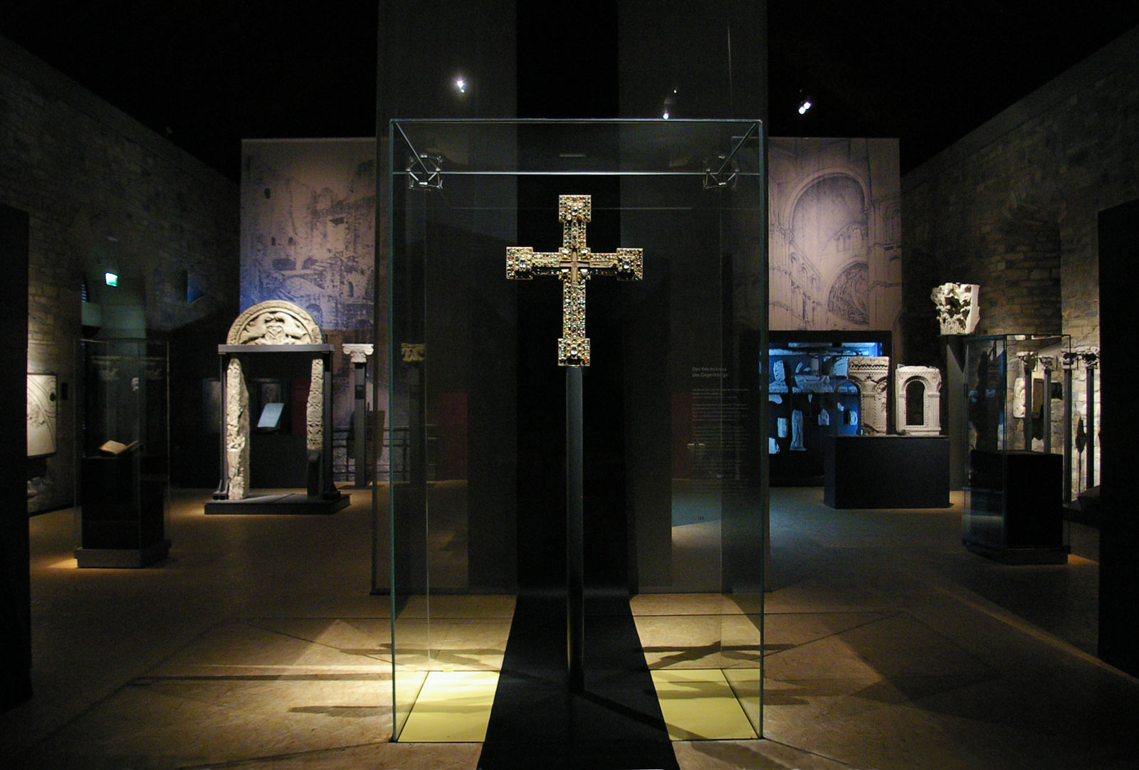 Das Referenzbild für Ausstellungsgestaltung aus der Sonderausstellung „Canossa 1077. Erschütterung der Welt“ zeigt eine Exponatpräsentation in einer Ganzglas-Vitrine.